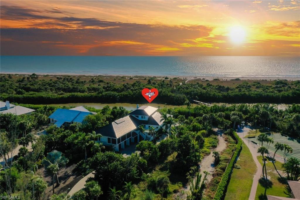 Serene Gulf-Front Vistas in Prestigious Gulf Ridge: Enjoy breathtaking Gulf-front scenery from this expertly remodeled, impeccably appointed residence set on one acre with direct western beach access in one of Sanibel’s premier communities—Gulf Ridge.This exceptional home features a Tesla roof with fully integrated solar panels and energy storage, powering the entire residence with remarkable efficiency. Owners typically enjoy average monthly electric bills of just $20–$30, a rare and valuable advantage. Upon entering, you’re welcomed by soaring volume ceilings and a spacious open floor plan ideal for modern coastal living. The great room flows seamlessly into an epicurean kitchen showcasing custom cabinetry, elegant quartz surfaces, and multiple refrigeration options suited for the discerning chef. The adjoining “Florida-style” dining room provides easy access to expansive outdoor living areas overlooking the Gulf of Mexico, the pool and spa, and preserved land beyond. Massive two-story decks extend from both the main living level and the primary suite, creating generous spaces for relaxation, dining, and entertaining. Guest suites are thoughtfully positioned on the main level, separate from the primary, each offering abundant natural light and deck access. The primary retreat is perched on the top floor, capturing panoramic views of the azure Gulf waters—a private sanctuary in every sense. A rare offering with exceptional refinement, privacy, and efficiency, 5145 is a true gem for the discerning buyer who values quality craftsmanship and timeless coastal elegance.