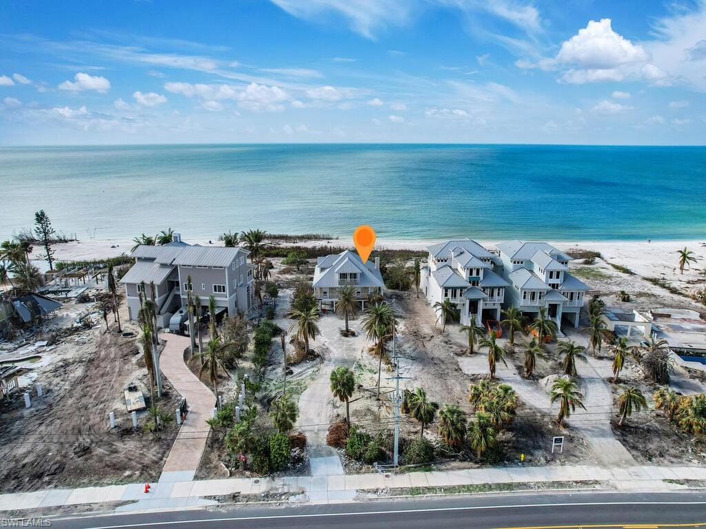 Rare Find. Approx 135 feet of AMAZING BEACH FRONTAGE! Situated on one of the largest oversized parcels on the beach (1 acre), this beachfront home is ideal for annual or seasonal SWFL living, plus it is perfect for a luxury vacation rental home. Investment opportunity- home is being sold AS-IS and has been gutted on main living area (second floor) 4 ft up from floor to remove water damaged areas from Hurricane Ian. The ground level has been washed out and the top floor is intact w/ guest suite w/ den & master suite w/ gorgeous waterfront view. The home offers an elevator shaft going to all floors, cement slab under entire home structure, great room design w/ panoramic view of Gulf of Mexico, long circular drive, and spacious backyard w/ plenty of room for a pool. Estero Island (Fort Myers Beach) is known for its relaxing coastal setting, beautiful beaches, and for having easy access to both mainland Fort Myers & Bonita Springs.