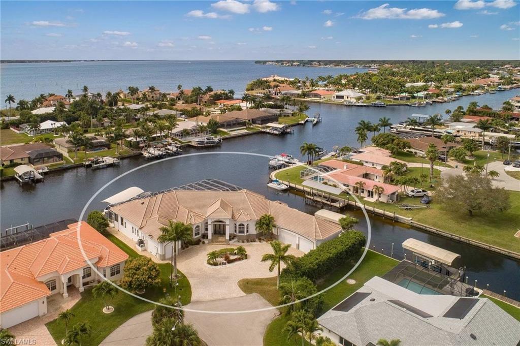DIRECT SAILBOAT ACCESS IMMACULATE PROPERTY ON INTERSECTING CANAL SOUTHWEST EXPOSURE.Minutes to open water,excellent property for large yacht.The house is on a oversized corner lot in a cul-de -sac with 263' waterfront.The design is very contemporary with a traditional feel.Custom built in 2013 with attention to details.Outside fabulous space with cedar ceiling,outdoor kitchen with fireplace,gas heated infinity edge pool and spa.With 4000 s.f. of inside living space and a large beautiful kitchen,formal dinning area with a wet bar services all the house.The 4 car garage oversized area has air conditioning plus additional 1 car garage.Surrounding the waterfront is a composite decking captains walk way,Beautiful Tiki hut,28000 lbs covered boat lift plus another for 10,000 lbs and a jet ski lift.Making this property excellent for boaters there is also a 60ft boat slip.4001 square footage under air with a total space of 9,447 squre feet.Exceptional property for primary,second home or fabulous vacation Rental.