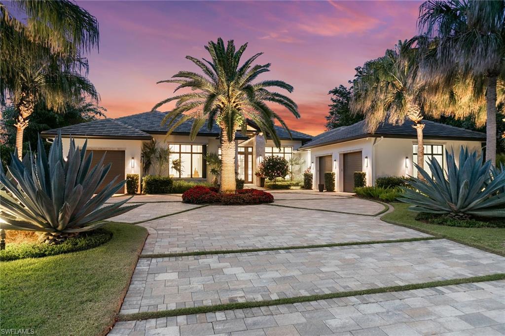 Welcome to a rare offering where architectural distinction meets effortless resort-style living. Built by Knauf-Koenig and masterfully designed by Stofft Cooney, this custom estate is tucked away on a lush and private half-acre homesite, one of the largest in Pelican Bay, and is the epitome of quiet luxury. From the moment you arrive, the natural textures of stone and wood, softened by layers of mature tropical landscaping, create a sense of calm sophistication. Inside, a relaxed contemporary interior unfolds, wide open spaces, walls of glass, curated designer furnishings, and finishes that exude refinement and ease. This is a home designed for living beautifully. Four spacious bedrooms with en suites, three distinct indoor living areas, and a glass-enclosed study overlooking what may be the most captivating pool and outdoor living space in Naples. Think: 50-foot resort-style pool, 8-foot infinity-edge spa, dramatic gas tiki torches, two separate lounge and dining areas, and complete privacy, your tropical sanctuary. The chef's kitchen features top-of-the-line appliances and custom cabinetry that seamlessly blend into the home's organic aesthetic. Every detail, from the millwork to the lighting, has been thoughtfully considered and executed to perfection. Just minutes from Waterside Shops, Artis-Naples, Mercato and the beach but you may never want to leave. Residents of Pelican Bay enjoy three miles of private beach access, two beachfront clubs with dining and towel service, a competitive tennis program, and Club Pelican Bay with 27 holes of golf, wellness amenities and fine dining. This is more than a home. It's a legacy property in one of Naples sought-after communities.