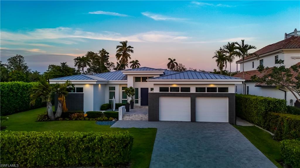 Situated in the prestigious boating community of Royal Harbor, this stunning residence sits on an oversized corner lot along a wide navigable waterway with direct Gulf access. Boasting a private dock with a 10,000 lb lift accommodating up to a 32-foot vessel, the home offers 4 bedrooms, 3.5 baths, and 3,339 square feet of luxurious living space. The open-concept floor plan is ideal for entertaining, with a spacious great room that flows seamlessly into the lanai and a gourmet kitchen featuring high-end finishes, Bosch electric cooktop, Sub-Zero refrigerator, wine refrigeration, separate wet bar, large island with quartz countertops, and custom cabinetry by Hyland. The primary suite is a true retreat with dual walk-in closets, an oversized walk-in shower with multiple heads, dual sinks, and a separate soaking tub. The outdoor living space is a private oasis, complete with a sparkling pool and spa, sun shelf, outdoor kitchen, wet bar, fire pit, and multiple seating areas perfect for relaxing or hosting guests. Additional features include impact windows and doors, an oversized two-car garage, EV charger, and generator hookup. Ideally located just minutes from the heart of downtown Naples, residents can indulge in world-class shopping and fine dining along 5th Avenue South and 3rd Street, as well as enjoy the sugar-sand beaches and vibrant cultural offerings that define the Naples lifestyle.