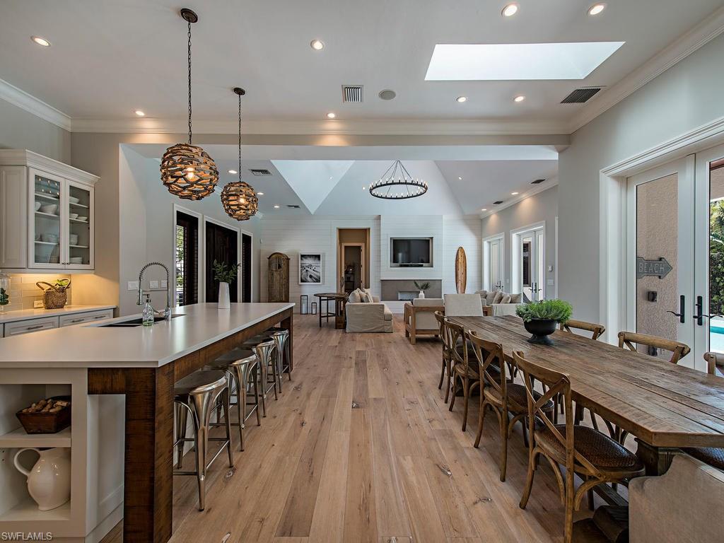 This home is a MUST SEE.  Located on one of the most beautiful streets in Old Naples, 1st Avenue North, this captivating residence situated in close proximity to the beach is a rare opportunity. The spectacular light-filled five-bedroom-plus-study home which was renovated and expanded in 2014 with high ceilings flows gracefully from one engaging space to another. The first-floor master suite offers a spa-like setting with double sinks, two walk-in closets and a dramatic view of the pool. On the second level, a loft and two additional guest bedrooms offer comfortable and private space for family and friends. The great room floor plan has numerous glass doors that lead out to an expansive outdoor living space that features a large pool and spa with an outdoor fireplace, dining area, and outdoor kitchen. The spacious lanai and pool area blend harmoniously with the exterior spaces and surrounding vegetation.