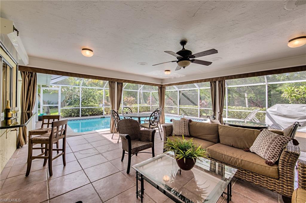 Desirable Fairview Isles Pool Home in overlooking park like backyard within easy walking distance to the beach or Santini Marina plaza for restaurants and shopping. 3 BED/2 FULL BATH home with Fireplace, covered lanai, large heated and screened pool, open concept living with split bedroom floor plan, ceramic tile throughout.  Updated kitchen with SS Dishwasher & fridge, pass through window to covered lanai and bar, great for indoor/outdoor entertaining all year long. Complete storm shutter protection. Attached garage has newer garage door and opener, plus side door for easy access to in house laundry room from garage. Sold Turnkey Furnished and with a 1 Year Home Protection Plan.
