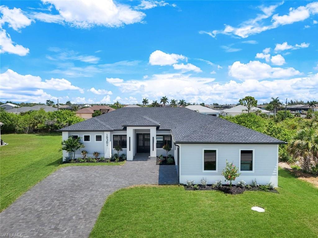Located in the sought-after South Gulf Cove community, this custom-built 4-bedroom, 3-bathroom home offers 2,349 square feet of modern living space with high-quality finishes and a thoughtfully designed layout. Tile flooring extends throughout the home, while impact-resistant windows and doors provide peace of mind and energy efficiency. The open-concept kitchen is designed for both function and style, featuring custom cabinetry, a built-in microwave, shiplap detailing on the oversized island, and a built-in bar that flows seamlessly into the main living areas, making entertaining effortless. The split-bedroom floor plan includes a spacious primary suite with a spa-inspired bathroom featuring dual vanities, a soaking tub, and a walk-in shower with multiple shower heads. A private guest suite with its own en-suite bathroom and direct access to the pool offers added flexibility for guests or multi-generational living. The backyard is designed for enjoying the Florida lifestyle with a private pool, built-in outdoor BBQ area, and a fully fenced yard offering both privacy and plenty of room to relax or entertain. A side-load garage completes the home's custom exterior and enhances its curb appeal. South Gulf Cove is known for its waterfront lifestyle, community parks, walking paths, public boat ramps, and convenient access to Charlotte Harbor, Gulf beaches, golf courses, shopping, dining, and all that Southwest Florida has to offer.