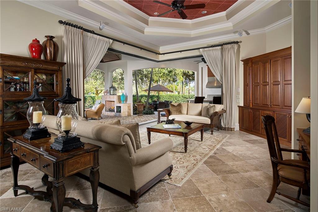 Enter your own private tropical paradise in this meticulously maintained home set on a generous pie-shaped lot to the west of the Moorings Golf Course. Perfectly capturing elements of a British Colonial style, this palatial retreat sprawls across a single level. High ceilings showcase intricate ceiling details, rich window treatments and gorgeous hand-painted walls. The main living areas open to an elaborate pool and spa surrounded by ample green space to the north, sitting areas under large trees to the south and a lanai complete with an outdoor kitchen and an intimate gathering area around a fireplace. Exotic granite counters grace the large kitchen island punctuated by five-star appliances and a 180-bottle wine cooler. Each of the spacious four bedrooms incorporates a private en-suite bathroom. An elegant game room hosts a classic pool table and space to relax indoors. The 5th bedroom could easily be modified to be a 3rd car garage. This is home is a must see for those desiring their own posh space surrounded by gorgeous golf course views, all in the heart of Naples.