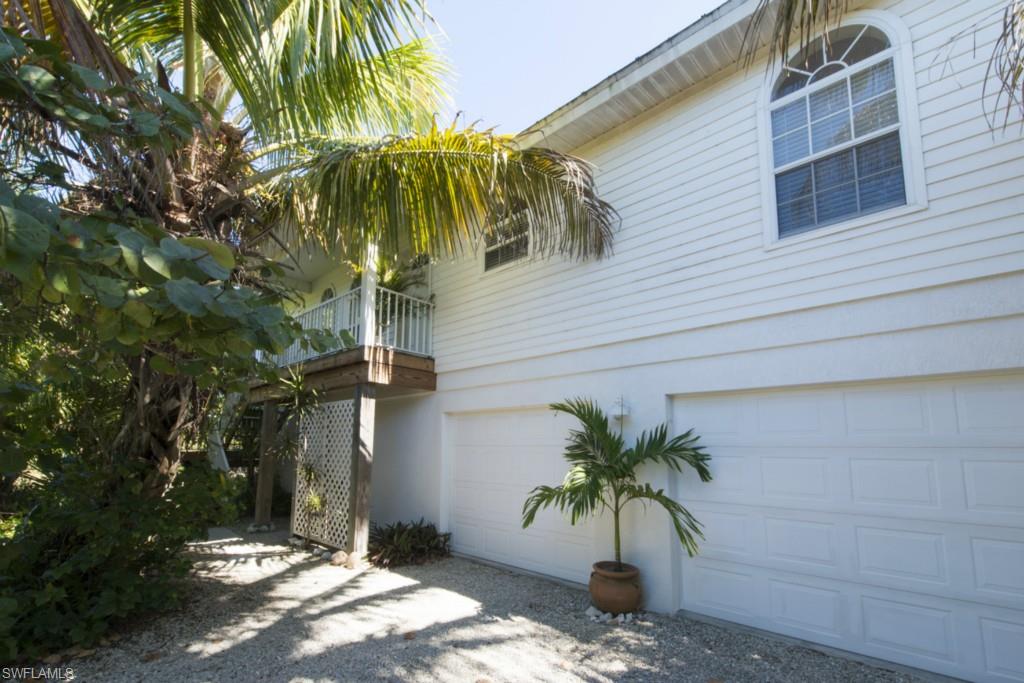 Adorable and very private elevated beach home.  Located at the end of a cul-de-sac in the desirable Sea Oats subdivision.  Open sliders to the screen-enclosed porch and enjoy privacy and preserve views.  Home backs up to dedicated conservation land.  Vaulted ceilings and an open floor plan.  Pretty white kitchen, split bedrooms, and tile floors throughout.  Laundry room and two car garage.  This home shows great.  Built in 2001 makes this one of the newer homes on Sanibel.  Easy walk to deeded beach access #1.