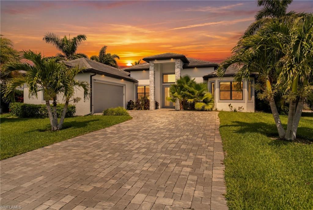 DIRECT SAILBOAT GULF ACCESS. NO BRIDGES. BUILT IN 2020. COVERED 14,000 LB BOAT LIFT. HEATED SALTWATER POOL. FOUR BEDROOMS. This custom waterfront home is located in Cape Coral's highly sought-after Savona neighborhood, known for its outstanding boating access and beautiful waterfront homes. Built in 2020, it offers a combination of newer construction and DIRECT SAILBOAT GULF ACCESS that is hard to find, along with a tile roof and an oversized 2.5-car side-load garage that add lasting value and outstanding curb appeal.
The waterfront is already set up with a composite captain's walk dock, covered 14,000 lb boat lift with canopy, and quick access to the Caloosahatchee River and the Gulf of Mexico. Snook, snapper, jack, and more can often be caught right from your own dock.
The backyard features a heated saltwater pool with sunshelf, outdoor kitchen, outdoor shower, and a spacious paver lanai. Eastern rear exposure offers beautiful sunrise views while helping keep the lanai cooler during the afternoon.
The open great room features soaring ceilings with tray ceilings and custom cloud lighting, a statement chandelier, an electric fireplace, and a floor-to-ceiling tile feature wall. Large sliding glass doors overlook the pool and canal, while large-format 24x24 tile flooring extends throughout the entire home with no carpet.
The kitchen features a waterfall-edge quartz island, European-style soft-close doors and drawers, Samsung appliances, a pot filler, under-cabinet lighting, a textured tile backsplash, and generous workspace.
The primary suite opens directly to the lanai and includes tray ceilings, dual vanities, a soaking tub, a spacious dual-entry walk-through shower, a transom window, and a walk-in closet. Three additional bedrooms provide flexibility for guests, family, a home office, or hobbies.
Additional features include impact windows and doors, a generator, paver driveway, city water and sewer with all assessments paid, and the peace of mind that this home has remained high and dry through Southwest Florida's recent major storms.
Savona is one of Cape Coral's most desirable waterfront neighborhoods, known for its one-way-in, one-way-out layout, exceptional boating access, and an optional neighborhood association with no mandatory HOA fees. Ideally located between the Cape Coral Parkway and Veterans Memorial Parkway bridges, you'll enjoy quick access to Fort Myers while being just minutes from South Cape, known for its locally owned restaurants, boutique shopping, entertainment, and year-round community events. Cape Coral's Yacht Club beach, fishing pier, and public boat ramp are also just a 5 to 10-minute drive away.
This is an opportunity to own a newer custom home with DIRECT SAILBOAT GULF ACCESS, a covered boat lift, heated saltwater pool, outdoor kitchen, and four bedrooms in one of Cape Coral's premier boating neighborhoods.