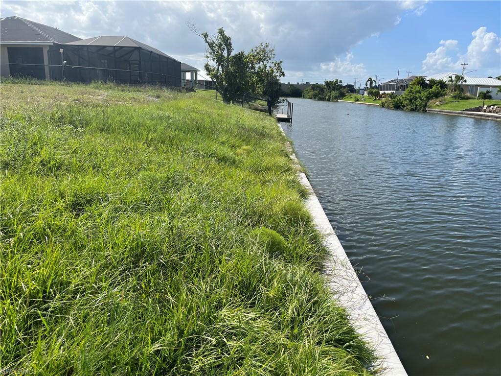 This is the dream home location you have been waiting for with all the hard pre construction prep work already done for you!  This waterfront lot has been cleared, has a brand new seawall in place, and is located in the heart of Cape Coral.  There will be no waiting on seawall permits, or contractors to begin construction of your brand new home in sunny Cape Coral FL.  This lot is on an expansive freshwater canal system that provides privacy, peaceful water views, fishing, and miles of kayaking opportunities.  This lot is also located within a few minute walk to one of Cape Corals best known craft drink bar's, 10 Twenty Five, and several other shops.   This is one of the last vacant lots in the neighborhood, and it also offers city water, and sewer with the assessments nearly paid in full!  Call today to secure this dream location for your new home!