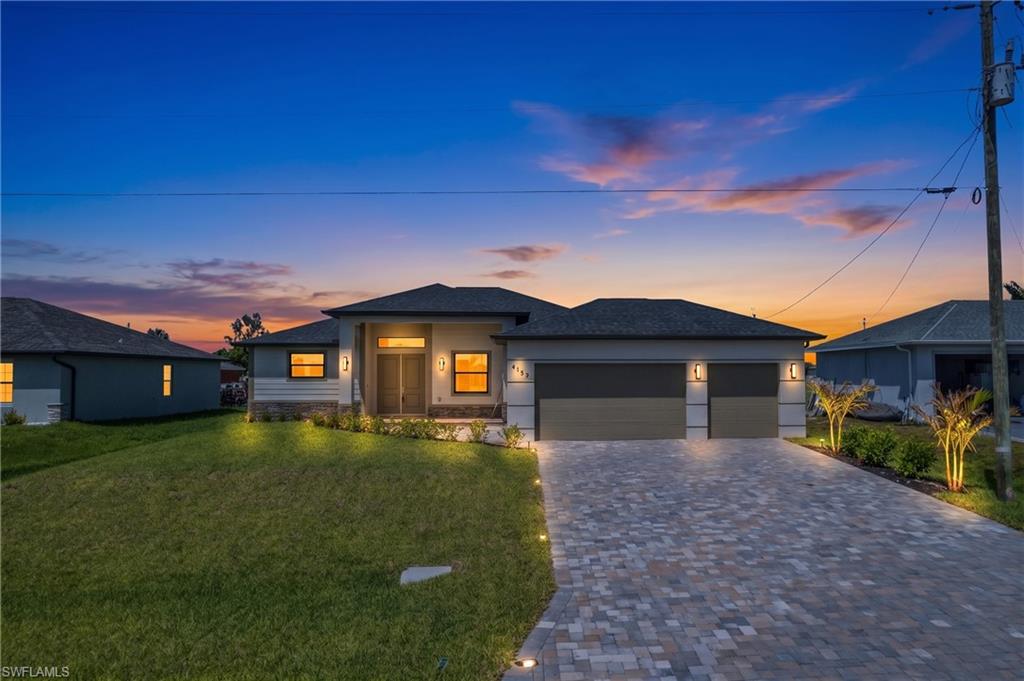 New Construction Pool Home offering 2,000 SFt of modern, light-filled living space with 3 bedrooms plus a den, 3 FULL bathrooms, and a 3-car garage. From the moment you walk in, it is clear this home was built and finished differently — with upgraded window coverings already installed throughout, large-format plank tile in every single room, and upgrades well beyond those of other new homes in the area. Step inside and the quality is immediate. Volume and tray ceilings open up the space, 8-foot interior doors elevate every room, and large-format plank tile runs throughout the entire home NO CARPET. The living room is a genuine gathering space, anchored by a dramatic feature wall with an electric fireplace and framed by high tray ceilings and a modern ceiling fan. Large impact-rated hurricane sliding glass doors connect the living area directly to the pool — the indoor-outdoor living is seamless and effortless. The kitchen is anything but ordinary. Dark grey solid wood cabinetry, a stylish backsplash, a cooktop with a professional vent hood, stainless steel appliances, a walk-in pantry with custom wood shelving, and a massive center island with a waterfall edge and exotic granite countertops create a kitchen that looks and performs like a luxury build at a fraction of the cost. This is not the standard builder kitchen buyers have come to expect. The split floor plan delivers exceptional privacy throughout. Two full primary suites — each with walk-in closets featuring custom wood shelving and sleek frameless glass showers. The primary suite overlooks the pool and features dual vanities, a walk-in shower, and a separate soaking tub. The fully enclosed den off the living room functions equally well as a home office, playroom, or converted 4th bed. Outside, the pool area spans the full width of the home's rear. The large heated pool sits within a new screen enclosure on an extended brick paver lanai, creating a private outdoor living space! The fully equipped outdoor kitchen features a built-in grill, mini-fridge, and sink. The backyard is fully fenced and fully landscaped, with a privacy fence. The 3-car garage features epoxy floors. Two of Cape Coral's most transformative development projects are taking shape in this exact corridor. The Seven Islands Project — approved unanimously by Cape Coral City Council in 2026 — will bring a Marriott-branded hotel with 240 rooms, waterfront restaurants, a tiki bar, a public marina with boat slips, a lagoon resort beach environment, condominiums, a community amphitheater, splash pad, dog park, kayak launch, and food truck park to nearby Old Burnt Store Road. Cape Coral Grove, a 131-acre mixed-use town center, will add over 1,000 residential units, a national grocer, major retailers, locally owned boutiques, a 136-room hotel, 4 public parks, and more! Bimini Square, The Cove at 47th, and Slipaway Marina further round out an entertainment, dining, and lifestyle.