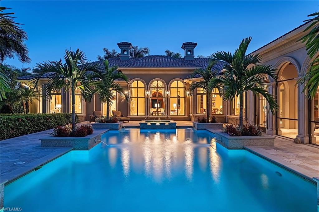 Spectacular panoramic double fairway views abound on the 4th fairway of the Estuary golf course from this luxury estate. This well-appointed home boasts 6,170 square feet of air-conditioned living space including five bedrooms, five full baths plus two half baths, study and an exercise room. Features include a 1,100-bottle temperature-controlled wine cellar, a wood-paneled library with coffered ceiling, a family room with vaulted ceilings, custom crafted wood entertainment center and natural gas-powered generator. An inviting gourmet kitchen is fully equipped with 2 dishwashers, 2 Sub-Zero refrigerator/freezer units, plus a multitude of top-of-the-line appliances. The expansive screened outdoor entertainment area includes a tongue and groove coffered ceiling, outdoor kitchen and bar, two TVs and wide-open views. A world of luxury awaits you in the completely renovated Grey Oaks country club community minutes from world-class shopping, beaches and dining.