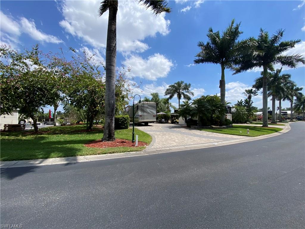 Lot 245 Is a sunrise lot overlooking a lake with water feature on it. Also, perfect location to view the remote control sailboat races durning season. You will find this lovely paved lot with Raised paver wall accents sets off this property nicely. The lot is buffered on one side with a parcel of common area giving you extra space between you and your neighbor on the coach side of the lot. This is a pull in site making it much easier for you to park your motorcoach. There is a permanent bar height table on the property that comfortably seats 4. The coach house is unfinished inside. Great for anyone just looking for storage or if you need a work shop. Nice landscaping within the property and beautiful flowering trees in the common property between you and your neighbor as well. Riverbend is a Golf cart & pet friendly community. Located on the banks of the Caloosahatchee River with a private boat ramp, Large pool, bocce, shuffleboard, putting green, horseshoes, hot tubs, Clubhouse overlooking river, covered picnic area, exercise room and community laundry room. 8 Pickleball courts open year round. R/C racetrack, hobby train under the oaks, billiards, bingo, R/C boating club and more.