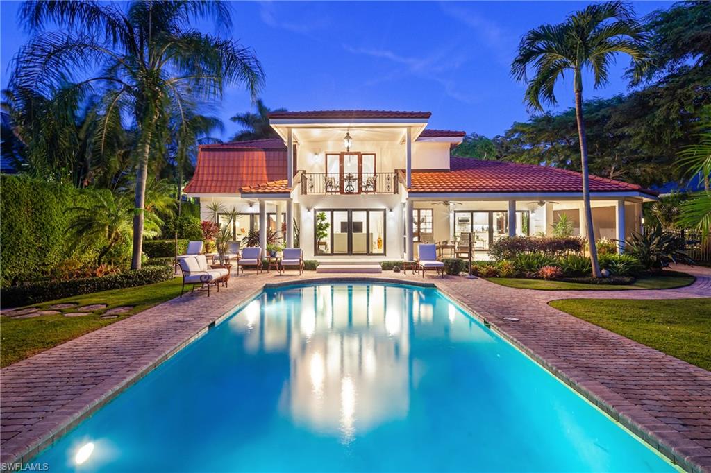 This exquisite estate in Port Royal is situated one block from the beautiful white sand beaches of Naples. A unique, deeded access path from the backyard provides direct access to the beach. This special property features mature trees and professional landscaping throughout including a serene pool with water feature, fountain and courtyard.  The fully renovated residence has two upstairs his and hers Owner bedroom suites each with balconies overlooking the pool and courtyard.  Two additional bedrooms, a bath and a sitting room are accessible by a separate staircase ideal for guests. A wrap-around screened porch adds even more living space and charm to the graceful home. Recent renovations created an open floorplan with new European white oak flooring, a contemporary kitchen with quartzite counters, Viking appliances, and a breakfast nook nestled in a bay window. The home features impact doors and windows throughout and a whole-home generator. Full Resident Port Royal Club membership eligible.