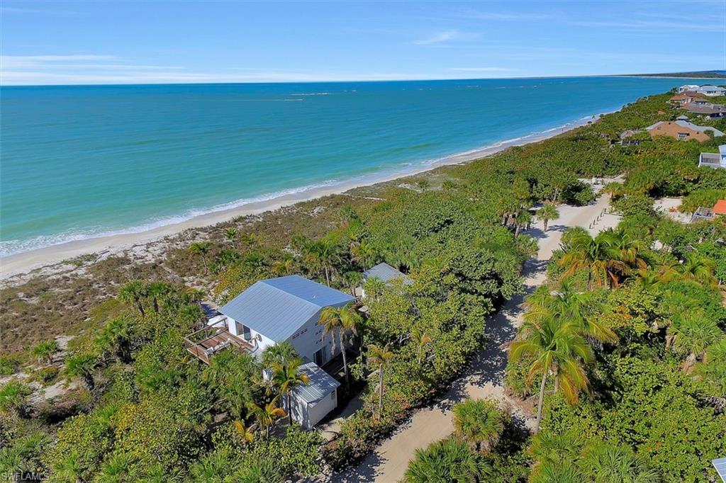 Please click on the video to view this gem of a home. 
This magnificent gulf front home
features wood frame construction and superior design
down to the smallest detail throughout the property.
Offering 2 bedrooms, 2.5 baths, Master bedroom is an amazing 600 sq. ft. with
open beam ceilings and a 180 degree view of the Gulf of Mexico and
200 ft. of beach front. Out to the deck off of the master bedroom where beautiful sunsets can be enjoyed.
The open floor plan of the living area has wood floors, slate countertops, slider window doors all around for spectacular Gulf views.
Expansive decking out any door. This property offers much privacy. 
Walk across the deck to a quaint cottage approx. 252 square ft. and features a bedroom and a full bath.