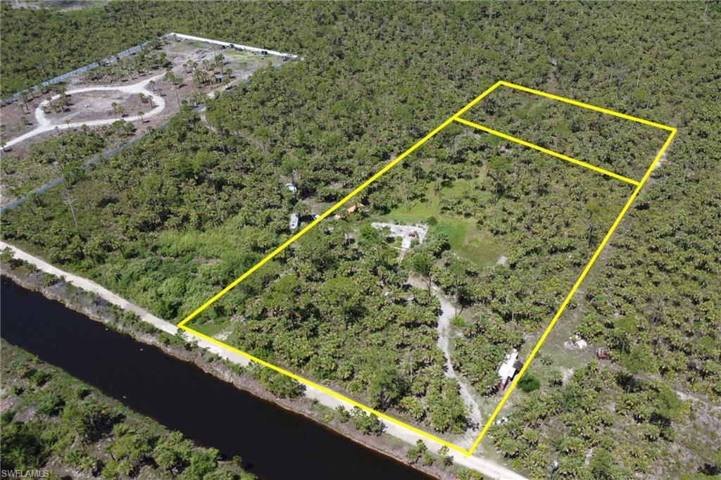 Discover this exceptional canal-front property located in a rapidly growing area of Golden Gate Estates. This is 5 acres altogether, with a 4 acre property in the front and a 1 acre property in the back. Featuring rare Agricultural zoning with more permitted uses and flexibility than a typical residential lot, this property offers outstanding potential for homeowners, investors, and those seeking a private estate setting.

The property is 100% uplands and includes a Letter of Map Amendment (LOMA), placing it outside of the flood zone and eliminating the requirement for flood insurance. A previous home existed on the site and has since been removed, creating a valuable opportunity for a new owner to rebuild while potentially saving significant time and money through existing development rights, permitting advantages, and impact fee credits.

Enjoy peaceful canal frontage, abundant space, and the freedom to create your vision in one of Collier County's most sought-after acreage communities. Whether you're planning a custom home, family compound, hobby farm, or long-term investment, this unique property offers the flexibility and foundation to make it happen.