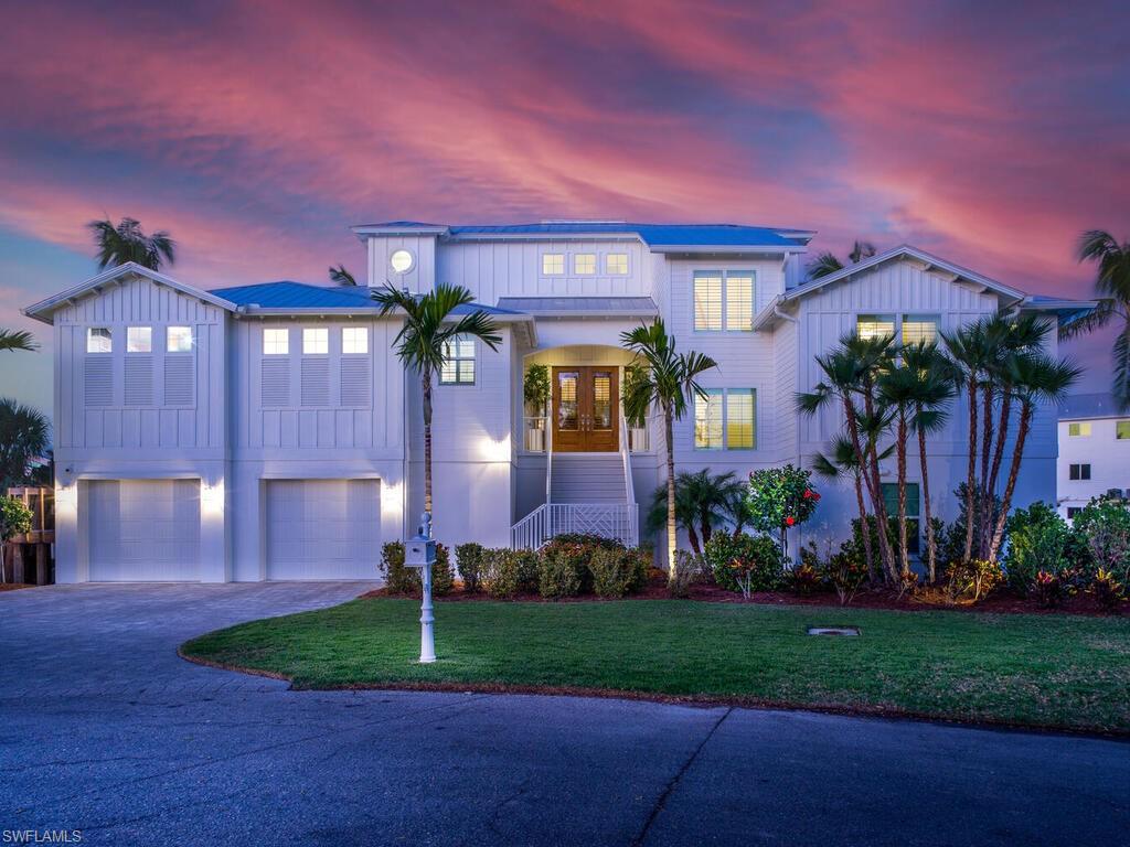 Luxury Coastal living at it's best.  This 2020 home has everything you could wish for.  With 3200+ square feet of living space there are 4 bedroom suites, an office/den, and open floorplan with a fireplaces in the living room and in the screened lanai overlooking the canal.  The warm wood flooring throughout the living area accents the painted shiplap walls and tongue and groove beamed ceilings.  The gourmet kitchen includes a 6 burner gas range, 2 dishwashers, wine chiller and so much more.  The current owner added a whole house generator and increased the propane capacity to 1,250 gallons - this home did not loose power during Hurricane Ian!  Also added was an instant hot water system, landscape lighting, and a 16,000 lb boat lift.  This is truly a special home and not to be missed.