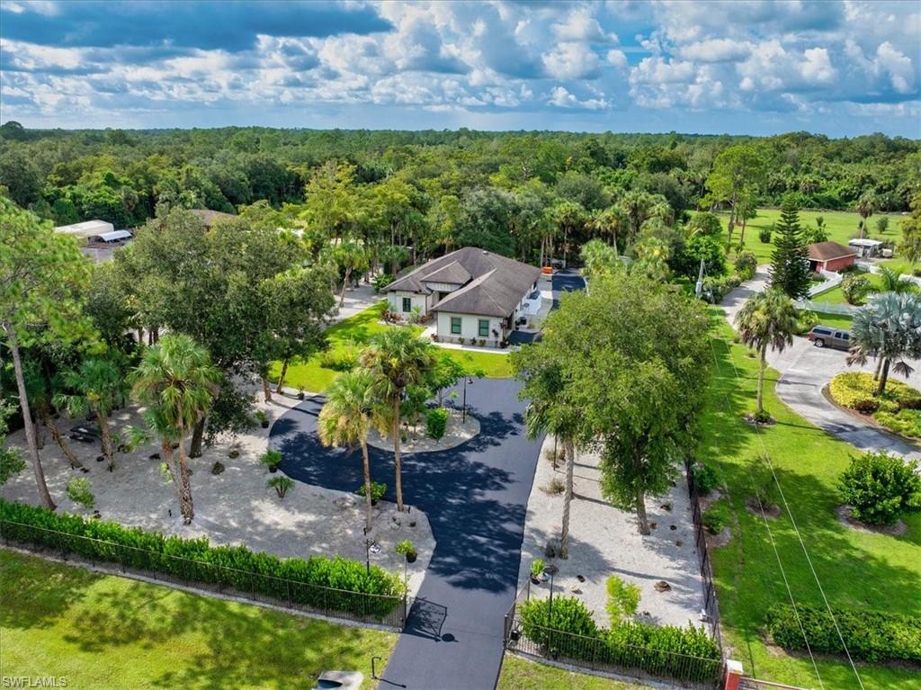 PRIVATE ESTATE LIVING in 2.27ACRES - NO HOA, NO Compromises! A RARE OPPORTUNITY to secure a property with both LIFESTYLE appeal & business functionality in the desirable Golden Gate Estates in Naples!, This private gated entrance & fully fenced 2.27-acre property offers space, privacy, freedom, lifestyle & checks off all the boxes including UPGRADES GALORE! Plus bonus - Seller OFFERING BUYERS INTEREST RATE BUY-DOWN with seller approved lender & accepted offer! 328 16th Ave NW delivers the rare combination of freedom & proximity to everything Naples has to offer, located off Wilson Blvd, HUGE location BONUS being just a few blocks from the newly opened Vanderbilt Beach Road Extension! Opportunities like this are increasingly rare in Naples, your imagination sets the limits. Step into elevated luxury Florida 4-Bedroom, 2-Bathroom Naples Estate. 4th Bedroom or Flex space as Office or Den. PRIDE OF OWNERSHIP Built in 2019, MOVE-IN READY & modern thoughtful upgrades, with a serene country-style living. It's sophisticated features & upgrades include HURRICANE-IMPACT WINDOWS & DOORS for peace of mind, PORCELAIN TILE flooring, 10-FT TRAY CEILINGS with CROWN MOLDING, WHITE PLANTATION SHUTTERS & CUSTOM LIGHTING, a WHOLE-HOUSE REVERSE OSMOSIS SYSTEM w/annual maintenance, EPOXY SEALED GARAGE FLOOR, NEW CARPORT AWNING, and MOTORIZED GRAND ENTRY GATE! A great opportunity for business owners such as CONTRACTORS, TRADESMAN, LANDSCAPERS RUN YOUR BUSINESS FROM HOME with EXTRA PARKING for CARS, TRAILERS, BOATS, RV's with plenty of room & gated drive right into the back of the property. Easy Care & Professionally Landscaped w/Sprinkler system & Fruit Trees, 100% LED, Indoor Living bright OPEN-SPLIT FLOOR PLAN creating the perfect balance of comfort and sophistication. Living Room features a modern wall fireplace and recessed lighting, flowing seamlessly to a chefs gourmet kitchen w/white shaker cabinetry, quartz countertops, black stainless steel appliances, and a custom-tiled breakfast bar. The dining area opens through sliding doors to a screened lanai, offering SOUTHERN EXPOSURE views of your private backyard oasis with plenty of ROOM to design your OWN CUSTOM POOL, Outdoor Entertaining & Relaxation! The backyard is a true retreat with a large paver patio, built-in fire-pit, hammock area, and room for the kids, grandchildren to play or your pets to have space to run! The luxury Master Suite boasts dual walk-in closets, custom wall finishes, and a spa-like en-suite bath. Three additional bedrooms provide space for family, guests, or a home office. Unbeatable Location! Enjoy quiet living with the all the conveniences in life close by - Publix, Bear Creek Elementary, Big Corkscrew Regional Park, NCH Hospital and shopping/dining etc.  No Construction Wait! VALUE! This is a chance to own acreage and to create your dream retreat in Naples!