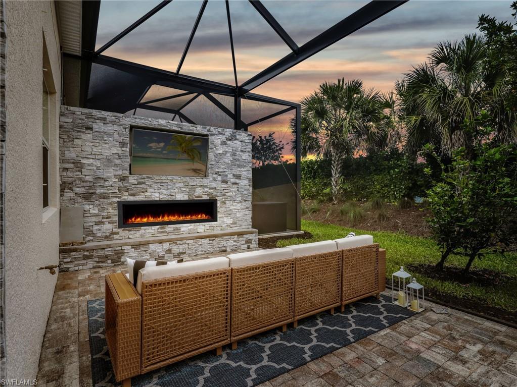One or more photo(s) has been virtually staged, AI generated or rendered.  MOVE IN READY!!! 1 year Home Tech home warranty included and seller will pay the remainder of the current year's HOA fees!!!

Exceptional outdoor living sets this beautifully maintained villa apart. The spacious screened lanai was designed for enjoying Southwest Florida's outdoor lifestyle, featuring a built in outdoor kitchen with grill, a fireplace that creates the perfect gathering spot, and an extended seating area that provides plenty of room for dining, relaxing, and entertaining. Matching pavers on both the lanai and driveway create a polished, cohesive appearance. The lanai's extended design creates an impressive outdoor living area, and the backyard offers the opportunity and space to add a pool, allowing the next owner to further enhance the property's outdoor appeal.

Inside, this 3 bedroom, 2 bathroom home offers 1,575 square feet of thoughtfully designed living space. Fresh interior paint and tile flooring throughout create a clean, updated look that is both attractive and easy to maintain. The entryway and dining area are accented with classic wall molding, while the living room features a custom shiplap accent wall that adds character and visual appeal. Plantation shutters throughout the living areas and bedrooms provide both style and privacy.

The kitchen offers a center island, tile backsplash, and abundant cabinet space. It flows directly into the main living area, creating a bright and functional layout ideal for everyday living and hosting guests. The spacious primary suite provides a comfortable owner's retreat with a large walk in closet and plenty of room for furnishings. The primary bathroom features dual sinks and a walk in shower. Two guest bedrooms are positioned on the opposite side of the home, creating privacy for both owners and visitors. These rooms offer flexibility for guests, a home office, or hobby space and are conveniently located near the guest bathroom. An indoor laundry room adds convenience, and the split bedroom floor plan further enhances privacy throughout the home.

Located in the highly sought after community of Azure at Hacienda Lakes, residents enjoy a gated setting with resort style amenities including a clubhouse, community pool, fitness center, tennis courts, pickleball courts, and beautifully maintained grounds. The property is also located outside of a flood zone, providing added peace of mind and potential insurance savings.