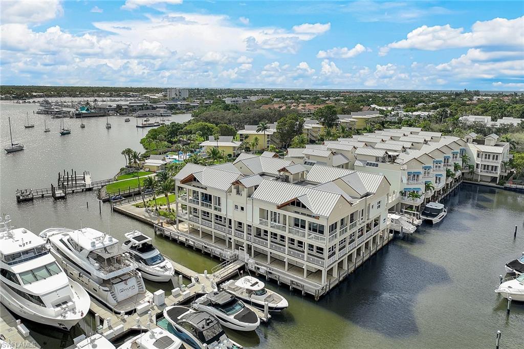 C11102 Step into this tranquil waterfront penthouse, where floor-to-ceiling windows frame mesmerizing BAY VIEWS! Awaken to captivating sunrises surrounded by constant "moving scenery"- luxury yachts, marine life, and the lively Sailing & Yacht Club. The interior boasts a chic AlliKristé custom kitchen featuring Quartzite countertops, Wolf steam & wall oven, 6 ft built-in wine fridge, double Sub-Zero fridge, and a NEW Thermador mirrored Induction stove top. The open concept kitchen and great room, adorned with a soaring beamed ceiling, seamlessly connect to a spacious wrap-around balcony offering an extended vista. The owner’s suite indulges in a vast en suite bath, custom His/Her joined closet and splendid Bay views through French doors. There are two additional ensuite bedrooms, each with private balconies, along with a versatile den/4th bedroom. This penthouse experience is elevated by a secure 2-car garage with semi-private elevator, ensuring convenience & privacy. Conveniently located steps from the shimmering pool, this residence places you within reach of both the beach & the vibrant downtown 3rd St. & 5th Ave shops & dining, elevating your lifestyle in this Naples gem!