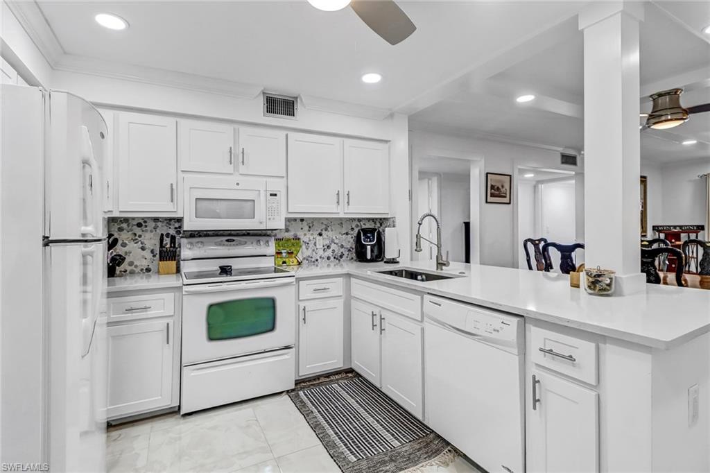 Introducing this Turnkey 2/2 condo in highly sought after Foxfire Golf & Country Club! This recently remodeled unit boasts a modern design, with great finishes and golf course views. Step inside and be greeted by an open-concept living area that is perfect for entertaining guests or enjoying quiet nights in. The spacious living area features tile floors throughout, plenty of light and an impact sliding door that leads to a private screened lanai. This cook's kitchen is sleek with quartz countertops, backsplash & updated cabinetry. The master is a cozy retreat with a walk in closet and en-suite bathroom with updated vanity, shower & modern fixtures. The guest bedroom has 2 twins and easy access to the guest bathroom that has been updated with a modern design. There is a full size washer & dryer, newer a/c 2021, designated parking, a storage closet on the screened in lanai and access to the community's amenities, including 27 holes of golf, tennis plus bocce courts, a fitness center & clubhouse with restaurant and bar . Don't miss out on this opportunity to own a turnkey condo in one of Naples' most sought-after communities less than 5 miles to downtown & the beaches.