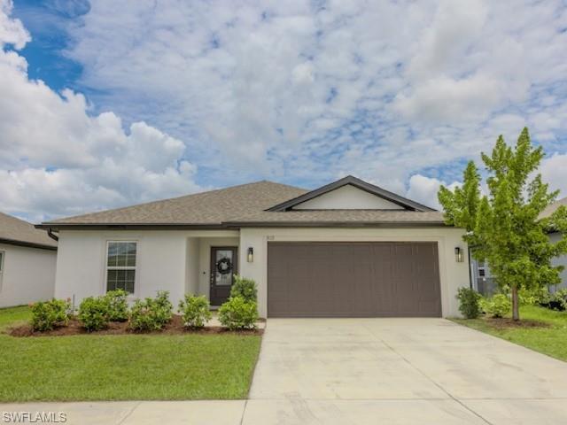 Well-maintained 3 bedroom, 2 bathroom single-family home in Arrowhead Reserve at Lake Trafford. Built in 2022, this 1,401 sq ft Amelia floor plan features an open layout with luxury vinyl plank flooring in the main living areas, carpeted bedrooms, and a neutral interior palette. The kitchen offers white cabinetry, tile backsplash, stainless steel appliances, and a spacious island overlooking the living and dining areas. The primary suite includes a private bath and walk-in closet. Enjoy lake views from the screened lanai, plus the convenience of an attached garage and newer major systems. Thoughtfully updated with modern finishes, refreshed landscaping, and move-in ready appeal.