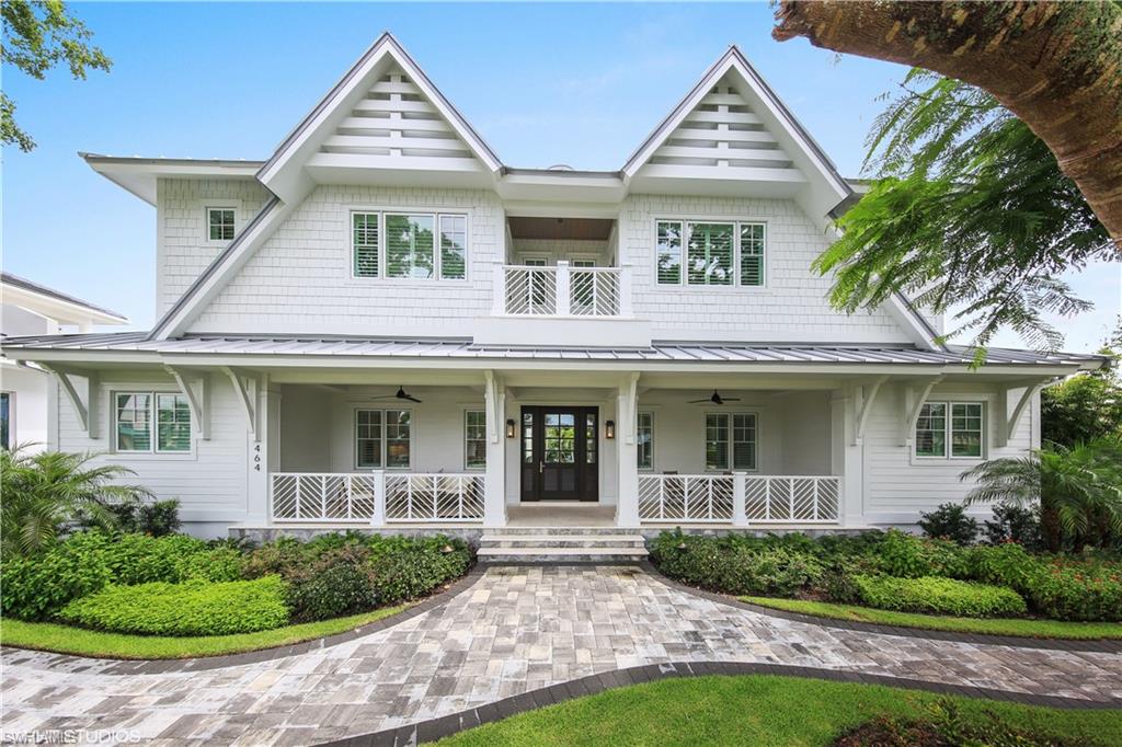 This new construction home located in Old Naples has a white coastal exterior surrounded by mature trees and beautiful landscaping. The chic interior is filled with natural light from soaring windows, delivering that open concept indoor/outdoor vibe. Wide plank European oak floors lend a beach-inspired feel to the transitional interiors. In the gourmet, white kitchen, custom cabinets and an oversized island are topped with beautiful quartz and a waterfall edge. In the adjoining two-story great room, there is plenty of space for family and friends to gather with views overlooking the sparkling pool. Main house features 5 bedrooms, second floor den and 5.5 baths. The luxurious master bedroom and bath exude tranquility. On the loggia, the outdoor kitchen and fireplace provide the perfect place for alfresco dining and evening lounging. The separate, private guest suite has a bedroom, full bath and kitchenette. Within walking distance to the crystal clear waters of the Gulf of Mexico, restaurants and shops at 3rd street promenade and 5th Avenue S, this location continues to be one of the most highly sought after neighborhoods in Naples.