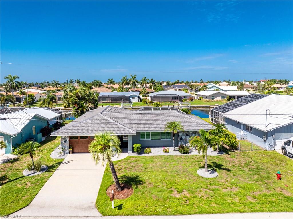 LIVE THE ULTIMATE PUNTA GORDA ISLES WATERFRONT LIFESTYLE! Perfectly positioned on 80 feet of city-maintained saltwater canal with less than a 15minute powerboat ride to Charlotte Harbor, this completely updated 4-bedroom, 3-bath pool home offers the ideal combination of luxury, comfort, and exceptional boating access. With desirable western rear exposure, you'll enjoy breathtaking sunsets from your screened lanai, heated saltwater pool - creating the perfect backdrop for relaxing evenings and entertaining. Designed for effortless  living and entertaining, the split-bedroom floor plan features formal living&dining rooms, a spacious family room, and an updated kitchen showcasing Bosch stainless steel appliances, including a built-in wine cooler. Luxury vinyl plank flooring flows throughout the home, while expansive sliding glass doors flood the interior with natural light and create a seamless transition to the screened lanai & pool,maximizing Florida's sought-after indoor-outdoor lifestyle. The primary suite offers direct access to the lanai & pool, while three additional bedrooms and three full baths provide comfortable accommodations for family and guests. The entire home has been renovated with exceptional attention to detail and quality. Major improvements include a new roof (2024)/ a transferable 10 year warranty, new HVAC (June 2026) with a transferable 10-year warranty, complete re-plumbing (2021), impact windows (2021), an impact-rated front entry door and garage door, R35 blown-in attic insulation (2024), new luxury vinyl plank flooring throughout, exterior repainting (2021), and professionally epoxied driveway, sidewalk, and garage floor. The outdoor living space has been equally enhanced with a heated saltwater pool resurfaced with PebbleTect (2021), new pool heater (2021), new pool pump and salt cell (2024), providing years of low-maintenance enjoyment. Located in the heart of Punta Gorda Isles, you'll enjoy one of SW Florida's premier waterfront communities where boating, fishing, kayaking, and spectacular sunsets are part of everyday life. Just minutes away, historic downtown Punta Gorda offers charming boutiques, art galleries, waterfront restaurants, Harborwalk, beautiful parks, golf courses, pickleball and tennis courts, the weekly Farmers Market, and Fishermen's Village for waterfront dining, shopping, and entertainment. Convenient access to Punta Gorda Airport, Interstate 75, and Gulf beaches makes this an outstanding location for both full-time residents and seasonalhomeowners. Whether you're searching for a primary residence, winter retreat, or exceptional waterfront investment, this beautifully renovated waterfront home delivers premium updates, spectacular sunset views, outstanding boating access, and the exceptional Southwest Florida lifestyle you've dreamed of. PLEASE VIEW THE ATTACHED VIRTUAL TOUR FOR MORE DETAILS. All dimensions & specifications are deemed to be accurate  should be verified by the buyer or buyer's agent.