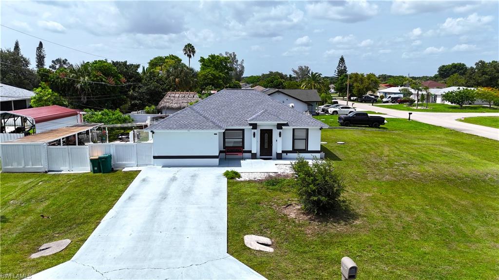 Discover the perfect blend of comfort, value, and versatility at 5225 23rd Ave SW, Naples, FL 34116! Situated on a desirable corner lot with extra outdoor space and no HOA restrictions, this well-maintained 3-bedroom, 2-bathroom home offers 1,218 sq. ft. of living space on a spacious 0.29-acre lot in the heart of Golden Gate City. Built in 2002, the property features a brand-new roof installed in 2026, storm shutters, and is located in an area where flood insurance is not required, providing added peace of mind and savings. Enjoy Florida living year-round with the open lanai, perfect for relaxing or entertaining. A standout feature is the private guest suite, complete with its own kitchen, full bathroom, living room, dining area, and washer and dryer, making it ideal for extended family, guests, or a private workspace. Conveniently located near schools, shopping, dining, and everyday amenities, this move-in-ready property offers exceptional flexibility, comfort, and value. Don't miss this rare opportunity to own a versatile Naples home with valuable updates and endless possibilities!