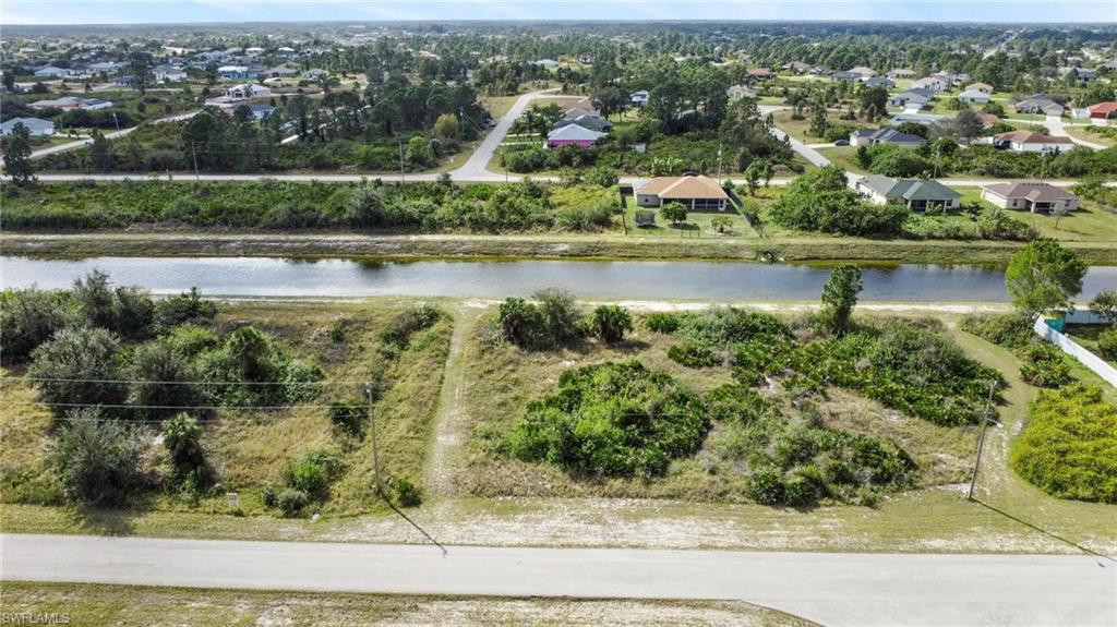 Welcome to the blank canvas waiting for you to create your dream home! This vacant lot is the perfect starting point for building your ideal oasis. With its sought-after Southwestern rear exposure, you'll enjoy breathtaking sunsets and an abundance of natural light. But that's not all the stunning canal located right in your own backyard, offering a serene and picturesque backdrop. Convenience is at your fingertips as this property is ideally located close to the heart of Lehigh Acres. Everything you need, from restaurants to shops, are just a stone's throw away. And for those who commute, Highway 82 is within easy reach, making your daily journeys a breeze. Don't miss this rare opportunity to create a home that reflects your personality and desires. Seize the chance to build a life that is uniquely yours.
