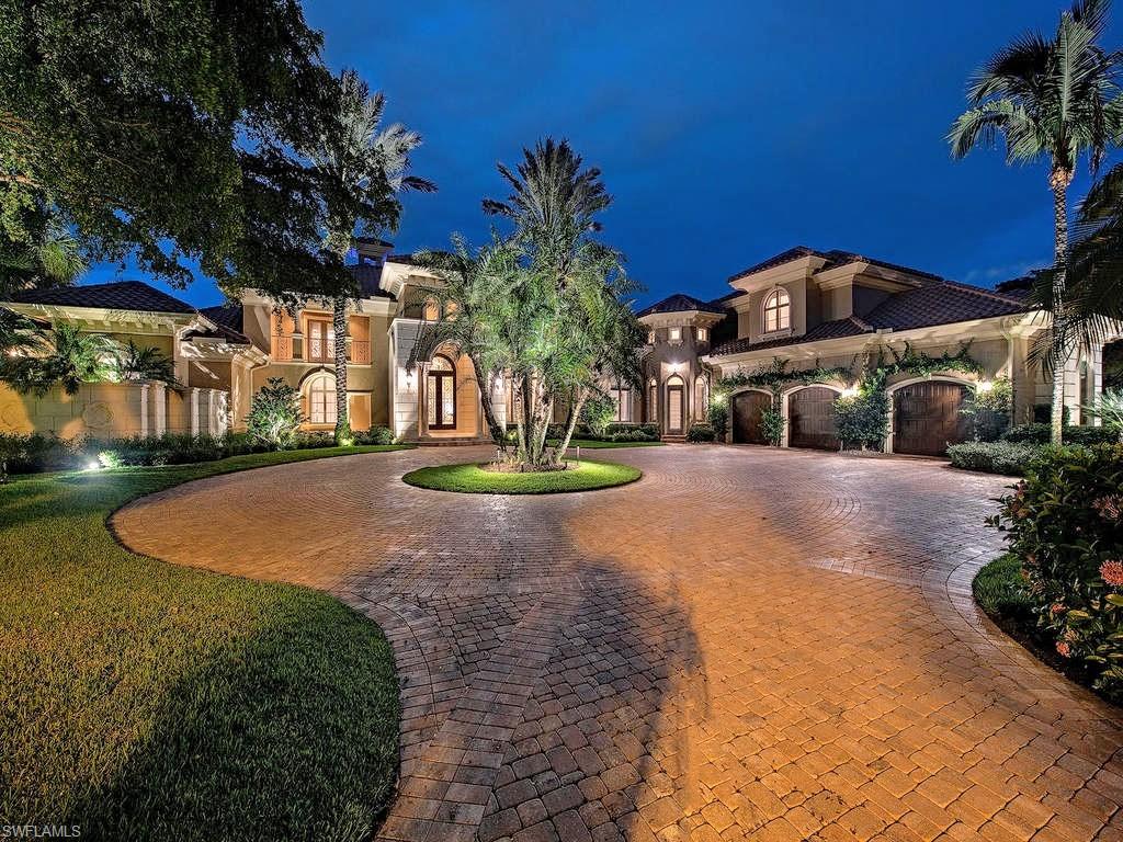 OWNER SAYS SELL! This home overlooks expansive panoramic lake and golf course views of the Palm course, one of three Championship golf courses within Grey Oaks Country Club.  Located in prestigious Isle Royale community, this home sits on a .85 acre lot in the quiet and private cul-de-sac of Canna Crt. A unique feature of this custom home includes two separate cabana suites each with their own outdoor kitchen/TV sitting area with gorgeous stone floors overlooking a large infinity pool and spa. The master suite with his/her bathrooms and large walk in closets, living room with see through gas fireplace, entertainment bar area and exquisite formal dining area are a must see.  The paneled library with spiral staircase and large safe is a gentleman's retreat. The bonus bedroom above the 3 car garage is wired for media, if desired. The chefs kitchen provides a Thermador professional 6 burner gas range, sub zero refrigerator, and warming drawer.  Added features of this beautiful home include vantage lighting, abundant storage, dog wash and run, new roof and exterior/interior paint and new landscaping.  Old Naples, shopping, fine dining, and airports just minutes away.