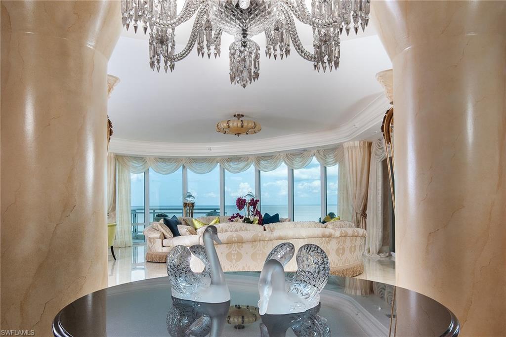 Best of all worlds. The extraordinary, expansive private terraces with your own access directly to the beach captures the ultimate beach house lifestyle in one of the finest estate high-rise resident buildings in Naples. Savor the relaxing seaside setting in style with magnificent Gulf and bay views. Nestled into the lush tropical setting, the spacious interior features extensive custom architectural design masterfully crafted, encompassing approximately 7,800 square feet of perfection for gracious living and entertainment including the terraces giving a total living area of approximately 8,860 square feet. Private access to the beach. Private three-car garage. Private wine cellar. Private elevator entry. Ultimate in privacy. Utmost in security. Unsurpassed amenities. All in the heart of the Gulf Shore.