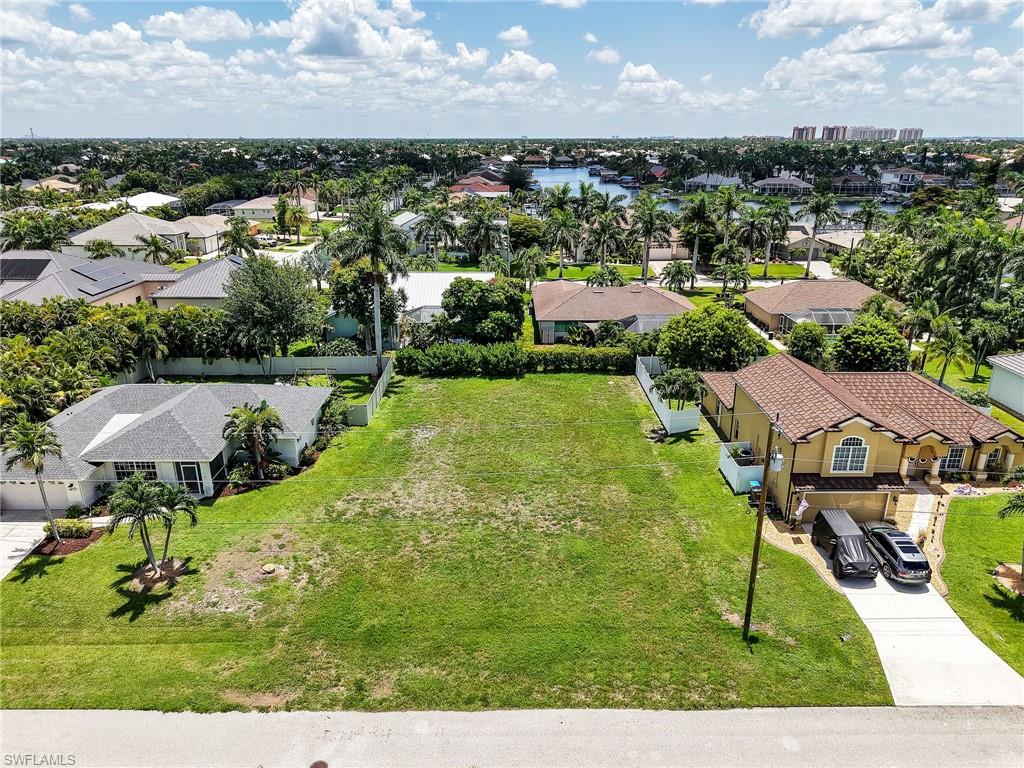 Build your vision on this cleared vacant lot in Southwest Cape Coral, surrounded by beautifully maintained custom homes and an established streetscape that reflects pride of ownership. With no HOA, you'll enjoy the freedom to design and build to your preferences while still benefiting from a neighborhood where pride of ownership is evident throughout and neighboring homes are maintained to a standard often found in deed restricted communities. Conveniently located near waterfront dining at Rumrunners and Fathoms Restaurant and Bar, as well as a Publix shopping center, you'll have easy access to restaurants, shopping, and everyday conveniences. Whether you're ready to build now or invest for the future, this prime homesite offers an outstanding location in one of Cape Coral's most sought after neighborhoods.