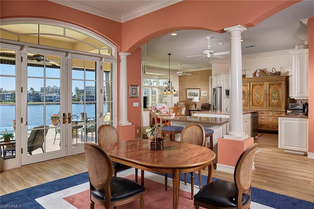 Sparkling lights of Moorings Bay are enchanting from this well maintained, great room design. Immediately upon entry, your eye is immediately drawn to the long view of the bay. A sprawling, first level, open floor plan with copious amounts of glass and ideal southwestern exposure allows for unsurpassed sunset views from nearly every room. Shutters for every window, new luxury vinyl flooring and a quiet location on one of the Moorings premier streets are just a few qualities that make this a great waterfront opportunity to make your own. Moorings residents will also appreciate the ability to join the Moorings Beach association.