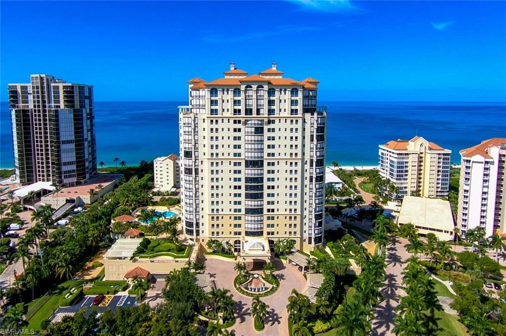 C6689. Gulf and City views up and down the coast of Naples are yours to enjoy from this 5th-floor residence in Seasons at Naples Cay! From the moment the doors of your private elevator glide open, every corner of this quietly opulent home commands your attention. With over 4,700 sq ft of living space, this stunning, light, and bright retreat lives like a single-family home without all the upkeep and features two separate living areas, spacious bedrooms with ensuite baths, and extensive wraparound screened lanai. The gourmet kitchen offers solid granite counters & backsplash, light, solid wooden cabinetry, double ovens, a built-in cappuccino machine, a wine cooler, dual sinks, and ample storage. The master suite is graced with a morning bar, Gulf views, and an ensuite bath with double sinks, a vanity area, jetted tub, dual walk-in closets, and a large shower. A private boardwalk delivers you to the powder-soft sandy beach right in your backyard. Additional Seasons amenities include a 24/7-manned gate and front entry, a pool and spa, fitness center, beach storage, billiards, sauna, and more! Located a stone’s throw from Waterside Shops and Artis--Naples. This gem is truly a must-see!