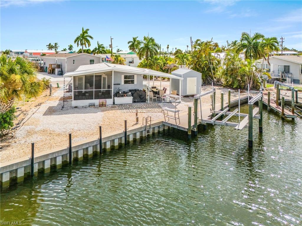 Tucked away in the quaint boating community of St. James City, this completely remodeled waterfront property offers a serene escape with direct Gulf access and breathtaking canal views. With over 90 ft. of seawall and boating dockage, there is plenty of room for your toys! Imagine stepping into a home where every detail has been thought of from the gleaming new flooring beneath your feet to the freshly painted walls that envelop you in warmth. The kitchen invites all to gather with a comfy breakfast bar and open concept for entertaining. Newer stainless appliances and pretty new cabinets make ready for the chef of the family.  Beyond the walls, a large expansive patio and screened lanai beckon you to unwind, providing an idyllic vantage point to gaze upon the waterway that leads to the majestic Gulf of Mexico. Whether you’re drawn by the allure of some of the best fishing right out your back door or the convenience of nearby dining, shopping, and seafood markets, this home is a gateway to the delights of coastal living. With beautiful beaches just a short boat ride away, this property isn't just a home; it's a lifestyle waiting to be embraced. With an extra large lot , you are able to store your RV on the east side of your home and hook right up to your own RV hookup!! Your surroundings are always alive with nearby craft markets, neighborhood music gatherings, festivals and lots of fun things to do. This is a great second home opportunity, fantastic investment property or home sweet home!!