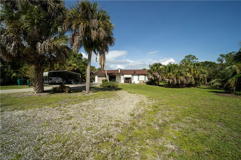 One or more photo(s) has been virtually staged, AI generated or rendered.  Discover the potential of this charming 2-bedroom, 2-bath concrete block home situated on 2.27 acres in one of Golden Gate Estates' most convenient locations. Nestled just off Golden Gate Blvd, this property offers easy access to shopping, dining, schools, and everything Naples has to offer while still providing the privacy and space that estate living is known for.

The home features a durable metal roof with the elegant appearance of tile, a functional floor plan, and a spacious screened lanai perfect for relaxing and enjoying the peaceful surroundings. An attached one-car garage, a detached carport, and a storage shed, providing plenty of room for vehicles, equipment, and hobbies.

The mostly cleared 2.27-acre lot offers endless possibilities—expand the home, add a guest house or workshop, create a garden, or simply enjoy the open space and privacy. Whether you're searching for a primary residence, seasonal retreat, or investment opportunity, this property presents an excellent chance to own acreage in one of Naples' most desirable rural communities.

Experience the freedom of Golden Gate Estates living with space, convenience, and unlimited potential.