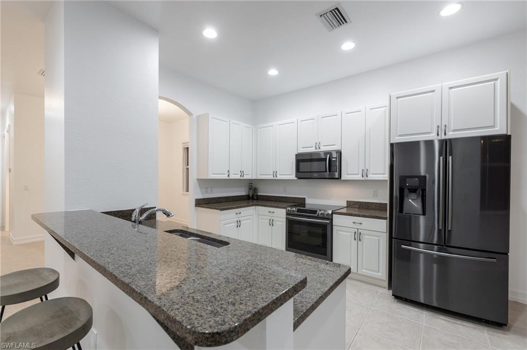 Looking for PRIME Location? THE ONLY 2+DEN currently available in PORTOFINO - a gated community located just off of Six Mile Cypress and across from TOP GOLF, Whole foods, Restaurants, Shops, Hospitals, bike trails, I-75, golf courses, Lee County bike & jogging trail system and much more! Freshly painted and spacious two Bedroom+Den with an attached two car garage. Large windows bring tons of natural light to every single room and the high ceilings and doorways gives this unit an extra luxurious touch! Have your morning coffee on your screened lanai accessible from both the living area and master bedroom and enjoy tropical views. The master suite is large enough to accommodate an entire collection of furniture and sitting area adjoining his & hers closet. Spacious master bathroom with double sink, soak in tub and separate walk in shower. This is a great floorplan for entertaining and the spacious guest bedroom & bath can be closed off as a suite. Newer ss (Samsung) appliances and AC. Brand new carpet and large laundry room. Gated community is very well maintained with a resort style pool and a huge sundeck.Low COA fees includes water, basic cable & more. VIRTUAL WALK THROUGH LINK
