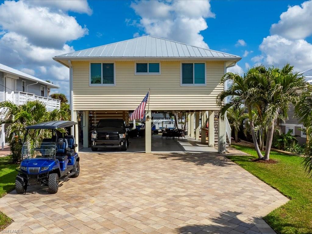 ***Key West Living in Bonita Springs!!! Welcome to 24550 Redfish Street!**** This welcoming 3-bedroom, 2-bathroom home built in 2015 will give you the lifestyle you’ve been looking for whether it is full time living, or your vacation home, you will find it here in the best-kept-secret-neighborhood of Bonita Springs! Sip coffee in the morning on your lanai and enjoy an occasional dolphin sighting in the canal below. The mature palm trees have been thoughtfully arranged to provide privacy, yet still allow you to enjoy the scenery. Your covered boat lift is primed and ready to launch your boat and whisk you out to the Gulf in less than 15 minutes where you can enjoy the beaches of Bonita Springs and colorful sunsets; or cruise north and dock at all the waterfront venues Fort Myers Beach has to offer. For the adventurous boater who prefers a longer ride, head south to Keewaydin Island for the day! Under the house you will appreciate the open, airy, and breezy space that is perfect for barbequing and entertaining your friends and family.Even on a rainy day, it's a gathering spot where you can still be outdoors while remaining out of the elements.The enclosed shed under the house provides ample space for storing your tools and other toys. And finally, you will be surrounded by some of the greatest neighbors in a wonderful community environment here on Redfish Street. But, .....you have to live here to experience it all! Easy to show and well worth your time so get out of the heat and enjoy the brand new HVAC installed in this property and come see this wonderful opportunity in the heart of Bonita Springs! A mile from the Hyatt resort as well as the new Ritz Carlton Residences and Coconut Point Mall! Only a 15 minute drive to RSW International airport and close to all the shopping, hospitals, schools, and restaurants SWFL has to offer.