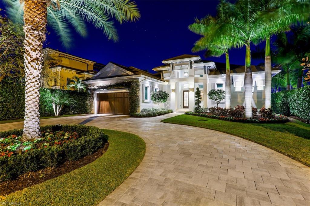 Discover the meaning of luxury waterfront living in the heart of Naples. This enchanting residence, complete with boat dock, lift and direct Gulf access, offers an impressive 6,150 sqft of indoor and outdoor spaces. The inviting floor plan merges both an open and formal concept for true Florida living. The great room opens onto a covered lanai and custom pool and spa that disappear into a much-desired water view. The outdoor living area includes a gas fireplace, motorized screens, summer kitchen, open-air dining area, large boat dock and lift. Interior features include a gas fireplace, wood flooring, voluminous ceilings, custom lighting, and impact windows and doors including large glass sliders. Custom kitchen cabinetry, Thermador appliances, and an oversized island for easy entertaining. The spacious master suite includes walk-in closets and a spa-like ensuite bath featuring dual vanities, a soaking tub, and a glass-enclosed shower with multiple showerheads. Multiple guest suites, large study with closet, laundry room, and oversized 2-car garage. The timeless design of this elegant residence is the epitome of coastal contemporary luxury living in Naples.