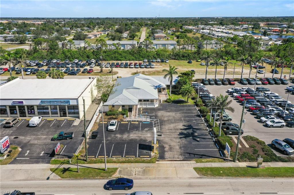 An exceptional, fully turnkey commercial real estate and business opportunity awaits at 1900 Tamiami Trail, where Units C and D have been combined into a commanding 2,600-square-foot facility (1,544 sq ft in Unit C and 1,056 sq ft in Unit D. This listing is for Units C & D only. Positioned directly on US-41 Northbound in Punta Gorda, Florida, this premium offering pairs the successful "Luxe Salon Suites" business with its underlying real estate, all backed by flexible Commercial Designated HC Zoning. The property boasts unparalleled exposure with 99 feet of prime highway frontage on US-41, complemented by an additional 99 feet of road frontage along Steadley Avenue at the rear. The other two units in this building (Units A&B) are occupied by a single Dentist Office. This location benefits from a robust Annual Average Daily Traffic (AADT) count of 36,000 vehicles according to the FDOT website—meaning an average of 36,000 vehicles pass the building each day, ensuring a massive stream of consistent exposure. Complete with great illuminated signage on US-41, easy access for customers, and plenty of parking (25 spaces up front with additional parking in the back), this building is a highly convenient business destination.

Inside, both units were fully combined and fully renovated in 2025, showcasing contemporary epoxy floors and uniform 8ft ceilings throughout the layout. The space includes a welcoming front reception area, two bathrooms, and a total of 12 possible suites. Currently, 10 of these rooms are set up as salon suites with plumbing in each suite, while a separate utility room houses a washer and dryer setup. One extra suite (Suite 7) is currently used as an additional break room and features a secondary set of washers and dryers. The property is designed for seamless, secure individual operations, equipped with two new zoned A/C units for custom climate control throughout the suites, and a specialized front-door intercom system that allows clients to dial individual suite numbers to be buzzed in directly. Cameras are in the front reception and around the exterior of the building provide total peace of mind. This offering is ideal for an entrepreneur looking to step into a thriving, plug-and-play location with strong potential for increased rental rates, or a savvy investor wanting to add a performing property to their real estate portfolio with a strong 7.1 cap rate fully rented out, and an even higher potential cap rate if the laundry break room (Suite 7) is leased out in the future.
Beyond its current successful operation, the building's premium 2025 updates, existing plumbing, high-traffic visibility, and versatile HC zoning make it easily adaptable for a wide array of alternative commercial uses. The private, multi-room layout and hygienic epoxy floors provide an effortless transition for an Aesthetics & MedSpa, an Oral Surgeon space, or a multi-provider Medical or Chiropractic Clinic needing clinical exam rooms. Call for appointmet!