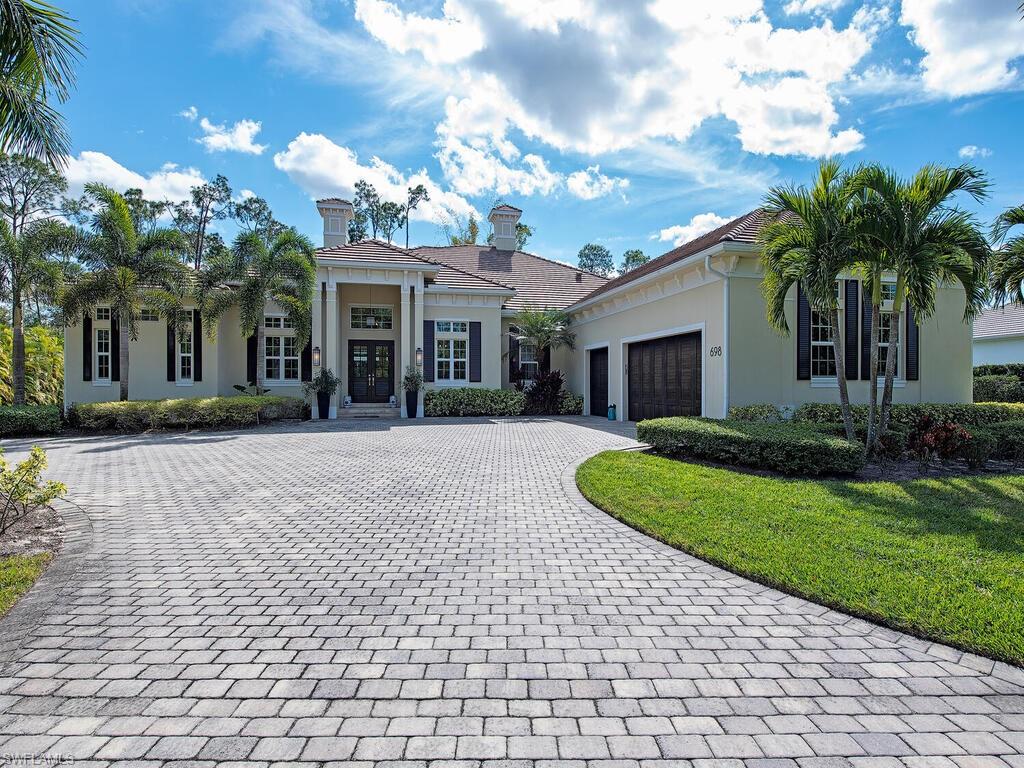 H4711 - Welcome to this wonderful custom-built home with open floor plan and sun-filled spaces throughout. You will find many upgraded features here including marble, white oak plank wood and tile flooring, soaring ceilings, vapor fireplace in the living room, an upscale kitchen with large island, quartz counter tops, convection wall oven, propane gas 6 burner range. The home is protected with impact-resistant windows and doors as well as roll down storm screens on lanai.  All rooms are generous in size and each bedroom has its own bath. The inviting outdoor oasis with propane gas-heated pool and spa, sun-filled deck, outdoor kitchen with built-in gas grill, gas fire pit and comfortable under-roof lanai space with a propane gas fireplace combine to provide the much sought-after luxurious Florida lifestyle. This property is enclosed with a fence and an electronic gate for added privacy. Minutes to beaches, shopping, and restaurants.