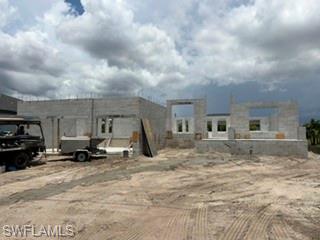 NOW under construction, this energy efficient 2265 sq. ft. home in NW Cape Coral includes 4 bedrooms, 3 baths, flex room and formal dining room with a large THREE -car garage. This plan provides lots of natural light, a high vaulted ceiling, and upgraded plank ceramic tile throughout ALL living areas. Home also includes elegant exterior French glass doors opening to a spacious 24' x 9' covered lanai. HOME FEATURES: Reverse Osmosis Filtration under the sink for clean drinking water / ice. Granite countertops in the kitchen and baths, stainless steel appliances, upgraded slow close cabinets.  Spacious primary bedroom with a large tiled shower, and Step Ceilings in the Primary BDRM, Flex Room, and Dining Room. The yard also features professional landscaping, a digital irrigation system, and low-maintenance Bahia.  New Adams Homes offer peace of mind with a standard comprehensive warranty package, including coverage for 1, 2, and 10 years! This ensures long-term protection for your investment. This newly under construction property presents an excellent opportunity to own a home in a quiet rapidly growing neighborhood close to everything you need for daily living. Please reach out today to arrange a viewing and experience all that this home has to offer! *Prices are subject to change.