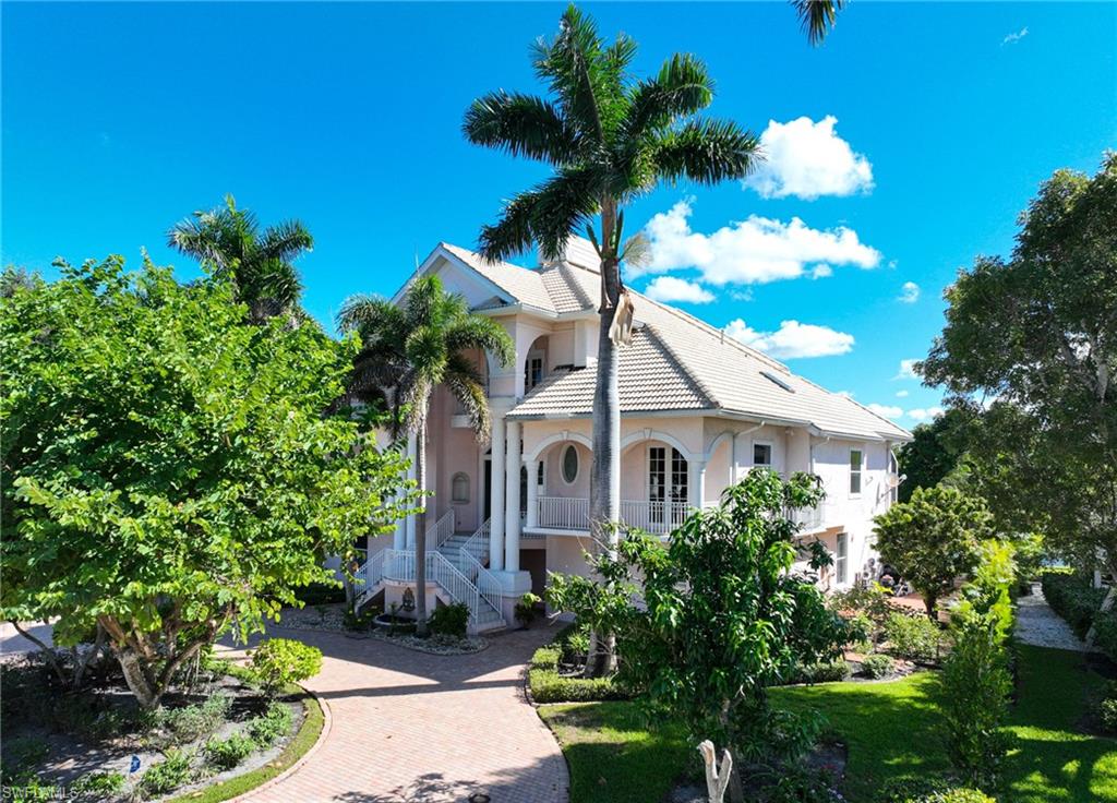 This one owner Barefoot Beach 6 bedroom/5-1/2 bath home is located in the double gated community of Southport on The Bay in convenient North Naples/Collier County. It is situated on a large lakefront lot just a short walk to beautiful Barefoot Beach via a dedicated beach access and to your own boat dock & lift on the bay with direct Gulf of America access and no bridges. This home’s floor plan is perfect for large family gatherings and entertaining and lilies on one level. Main living level has a large great room, dining room, in-eat kitchen, with direct access to the large outdoor areas plus the master bedroom suite separate shower & bath, walk in closets, den/office, 2 guest bedrooms, and large storage areas. The 2nd floor offers guest bedrooms and baths. There is a large walk-out to the landscaped yard and pool area that overlooks the lake and fountain. There is a separate work area on the lower level, a 2 car garage and private elevator to all 3 levels. The outdoor landscaping provides privacy surrounding the property and for your enjoyment of the pool, spa, and 2 story screened lanai. This home is in its original condition and ready for your to transform it into your own piece of paradise. Nestled in Collier County’s gated Barefoot Beach community amenities include 24 hour guards and patrols. Option to join the Club at Barefoot Beach (located in the community) which offers casual & fine dining restaurants, pool & beachside food, drinks, chair service, indoor & outdoor bars, ice cream & coffee shop, tennis courts with pro & a full events calendar. (waitlist with usage during wait period). Minutes to Mercato, Promenade & Waterside, the airports, dining, entertainment and golfing.