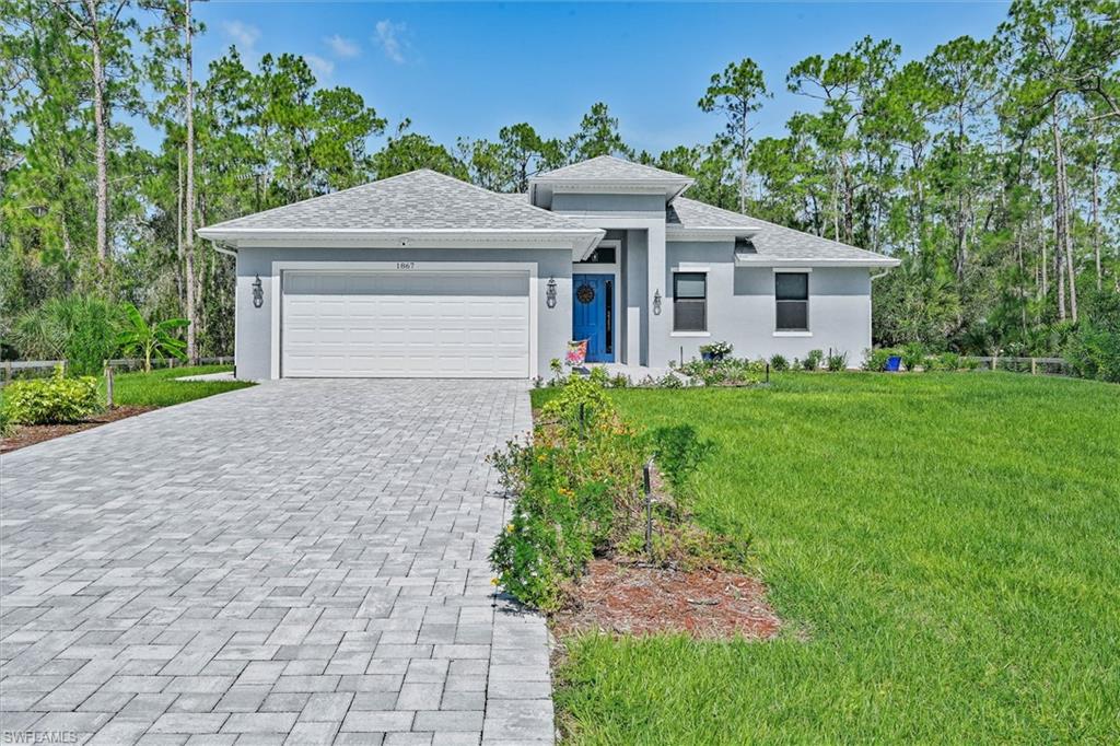 Embrace a lifestyle of privacy and peace in this exceptional Lehigh Acres home, nestled in a quiet, solitude area of Grenbriar where no HOA fees mean you’re free to live life on your terms. A fully fenced property with a powered entry gate sets the tone, as elegant pavers lead you from the street directly to the front door and extend along charming walkways to your detached shed or “man cave,” complete with full A/C and stylish vinyl plank flooring. Picture yourself surrounded by mature fruit trees and lush tropical landscaping, just a scenic walk from the Frank Mann Preserve. There you’ll find miles of hiking trails, fishing spots, and canoeing access. The perfect complement to the solitude you’ll enjoy at home. The outdoor living continues with a beautiful fire pit area for evening gatherings, plus ample side yard space to store your boat behind a manual gate. With room for an RV and space to add your own pool, the oversized 0.51 acre lot offering true country living on a paved city maintained road.
Take in breathtaking sunrise and sunset views from the property, where the garden boasts Caloosa trees and a variety of tropical plants. Inside, the split-bedroom floor plan features three bedrooms and two bathrooms, with porcelain tile flowing throughout for a clean, modern feel. The oversized master suite is a private retreat, large enough for a king-size bed and showcasing two custom walk-in closets, dual vanity sinks, a luxurious soaking tub, and a tub/shower combination accented by decorative Turkish tile. High ceilings, ceiling fans in every room, and a stunning chandelier in the living room enhance the home’s open, airy feel.
The kitchen is designed for both function and style, with granite countertops, a breakfast bar, and an Osmosis water filtration system. A separate laundry room, full gutter and downspout system, and on-demand Rheem water heater add everyday convenience. Fishermen will appreciate the bonus kitchen in the two-car garage — perfect for cleaning your catch without bringing the mess inside. Step outside to a gardener’s paradise, where an irrigation system nurtures aloe, pineapples, mangoes, bananas, butterfly plants, and other exotic varieties. This is more than a home, it’s a private sanctuary where solitude, beauty, and modern upgrades come together at the best price in the area. Your Florida oasis awaits. (One or more photo(s) has been virtually staged, AI generated or rendered)