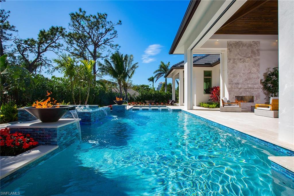 Situated on almost a 1/2 acre southern exposed lot, this new construction home is unlike any other.  The sprawling, single story home has almost 5,000 square feet under air with 5 bedrooms plus a den. Upon entry, owners will be greeted with wide plank, white European wood flooring that lead to floor to ceiling doors, allowing natural light to permeate the entire home. Unsurpassed quality and special attention to detail, this home leaves no detail behind; soaring ceilings, a resort inspired outdoor area with 2 covered living areas, outdoor kitchen, fireplace, fire bowls, and spa with charming walkway to your fire pit and trellis covered private gate conveniently placed for easy access for nearby shopping and dining at Waterside Shoppes, Venetian Village and Neapolitan Shopping Center. The extended corner lot allows for a three-car garage connected to a private porte-cochere, which could be converted to a fourth garage or guest cabana. Residents are eligible for membership to the Park Shore Association, offering beach access and eligibility to lease or purchase a boat slip at the Venetian Bay Yacht Club.