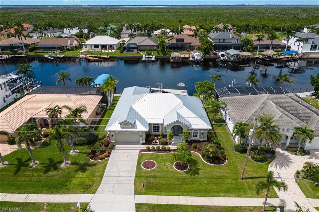Experience the best of Southwest Florida waterfront living in this beautifully maintained direct Gulf access pool home in one of Southwest Cape Coral's most desirable boating neighborhoods. Perfectly positioned with western exposure, you'll enjoy breathtaking sunsets from your lanai while overlooking a 200 foot wide canal. Inside, vaulted ceilings and an abundance of natural light create a bright, inviting atmosphere throughout the home. The kitchen features granite countertops, stainless steel appliances, and overlooks the main living area, making it ideal for entertaining. The spacious primary suite offers a relaxing retreat, while the den provides the flexibility of a home office, media room, or additional guest space. Step outside to your private waterfront oasis featuring a sparkling pool, private dock, and 10,000-pound boat lift. With direct Gulf access, you can spend your days exploring the Caloosahatchee River, nearby beaches, waterfront restaurants, and the Gulf of Mexico—all just a boat ride from your backyard.
Recent updates include a 2019 roof, newer A/C, and newer water heater for added peace of mind. Conveniently located near Cape Harbour, Tarpon Point, shopping, dining, and entertainment, this home offers the perfect blend of boating, relaxation, and the Southwest Florida lifestyle.