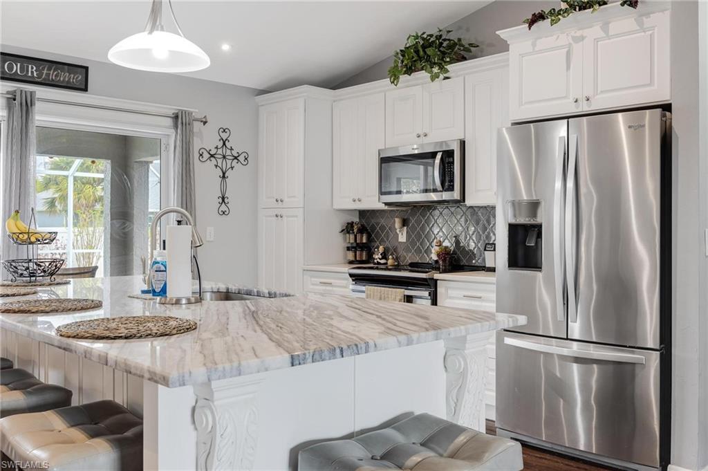 This pool home is located in a quiet area close to Burntstore and Pine Island. When you first walk in, you will be amazed at the creativity that went into utilizing the space. Its vaulted ceilings, the kitchen with quartz counter tops, wine fridge, stainless steel appliances and soft close cabinetry, is a real focal point leading out to the relaxing pool area, with fenced in backyard. Pool heater was added and was also resurfaced and tiled in 2018. The whole house was replumbed in 2017.