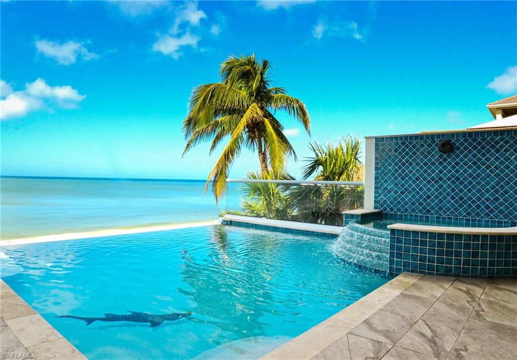Fantastic Bonita Beach home! The main living level includes two private guest suites w/ full baths, guest laundry, custom bar w/ seating, and a gourmet kitchen that includes Thermador appliances, breakfast bar & stunning custom cabinetry.  The great room offers intricate ceiling detail & panoramic Gulf views. An elevated pool & spa can be found off of the main living level with glass railings to maximize Gulf views, outdoor kitchen, and convenient pool bath. The 3rd floor features the master bedroom, bonus/entertaining room with full bath, and study/home office. The master bedroom includes a private lanai with spa, fireplace and a spacious bathroom w/ Toto toilet, heated floors, walk-in shower w/ seamless glass door & multiple shower heads. The bonus room features custom bar, gorgeous wood lined ceilings, & lanai overlooking the Gulf of Mexico. Three car plus garage. A stunning beach home!