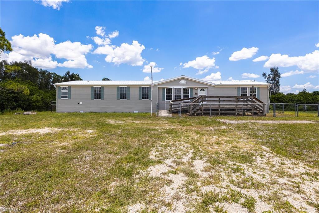 Escape the hustle and bustle with this private 10-acre AG-2 zoned property in North Fort Myers, just minutes from Babcock Ranch. Offering the perfect blend of seclusion and convenience, this spacious 4-bedroom, 3-bath manufactured home features a flexible floor plan, including a private owner's suite with an adjoining room ideal for a home office, nursery, or sitting area. Step outside to enjoy the beautiful in-ground pool, added in 2024, featuring a sun shelf entry and decorative water feature. Equestrian and hobby farm enthusiasts will appreciate the pole barn for horses and the large metal Quonset hut, providing ample storage for equipment, vehicles, or workshop space. The home features a durable metal roof and is located in desirable Flood Zone X. Add your own finishing touches to this home and property to create your dream country estate while enjoying the privacy, versatility, and endless possibilities this unique property has to offer.