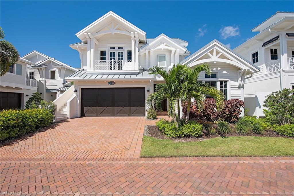 Stunning single-family home in Mangrove Bay. Coastal chic design with soaring ceilings, detailed millwork, European white oak flooring and designer lighting, finishes and furnishings throughout. Open floor plan featuring a large living room with custom built-ins framing a fabulous fireplace. Large gourmet kitchen with Ruffino cabinetry, gas cooking, Wolf/Sub-Zero and expansive island. This sought-after Amelia III floor plan features a spacious main house with 3 bedrooms, 3 full baths, den, powder room and laundry room all on one level, plus a private second level guest cottage with additional bedroom and bath above the two-car garage. Outdoor living complete with fireplace, outdoor kitchen, covered seating area with retractable screens, heater pool and spa surrounded by shellstone. Located on the mangrove side with boat slip #40 on the other side, included with purchase. Community amenities include a fitness room, resident lounge, kayak/paddleboard storage and boat ramp. Mangrove Bay is located along the Gordon River and adjacent to Baker Park. Nearby shopping, dining, downtown/5th Ave and beach access.
