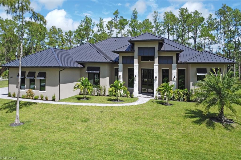 Rarely available on one of the best streets in Logan Woods, this estate rests on nearly 3 acres with a unique lot design in a peaceful end location. Logan Woods is one of Naples’ most desirable neighborhoods, loved for its quiet charm and no HOA restrictions—all while being just 10 minutes to I-75, Physician’s Regional Hospital, Mercato, Seed to Table, fine dining, and Naples’ world-famous beaches. Inside, enjoy soaring ceilings, wood-look porcelain tile, and a chef’s kitchen with custom two-tone cabinetry, premium appliances, gas range, and walk-in pantry. The primary suite is a spa-inspired retreat with direct pool access, while each additional room features an en-suite bath and walk-in closet. Outdoors, the screened lanai with vaulted ceilings, summer kitchen, fireplace, and sparkling pool delivers the ultimate Florida lifestyle. A one-of-a-kind blend of privacy, furnished elegance, and exceptional value in a top-rated school district.